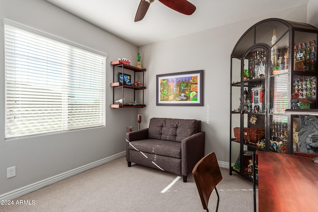 living area with ceiling fan and carpet floors