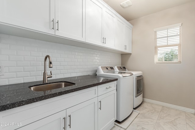 washroom featuring cabinets, washer and dryer, and sink