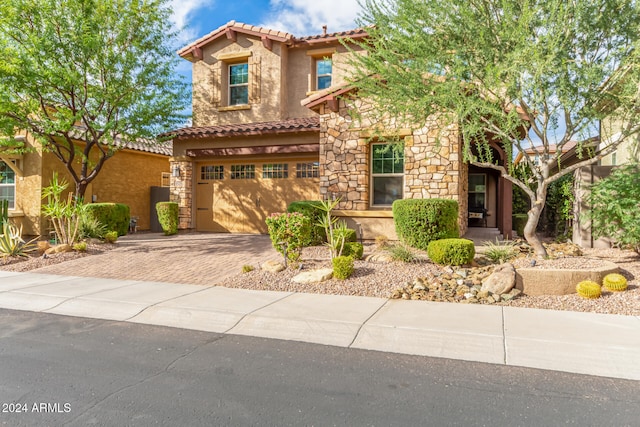 mediterranean / spanish-style home featuring a garage