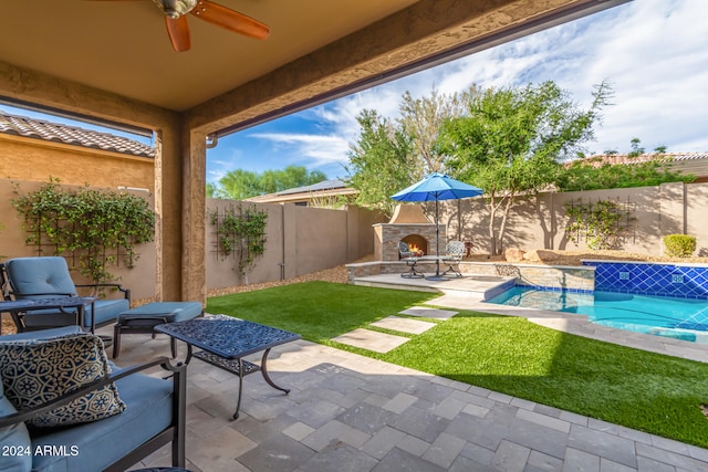 view of patio / terrace with ceiling fan and a fenced in pool