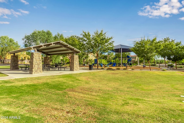 view of home's community with a playground and a yard