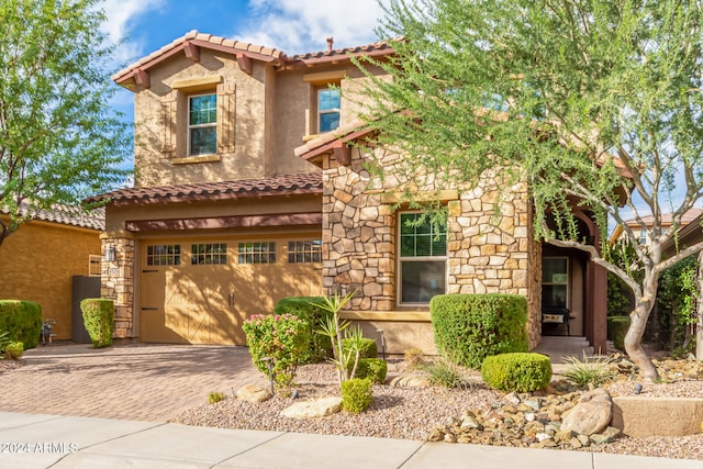 mediterranean / spanish-style house with a garage