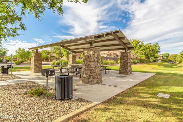 view of property's community with a lawn, a patio, and a gazebo