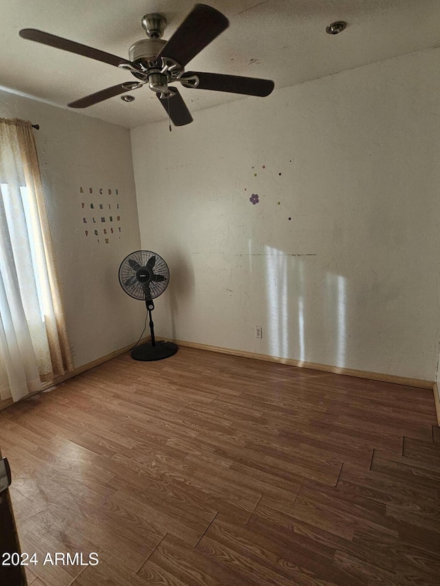 unfurnished room with hardwood / wood-style flooring and ceiling fan