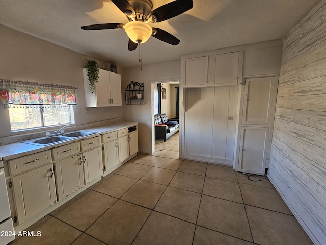 kitchen with white cabinets, ceiling fan, light tile patterned floors, and sink