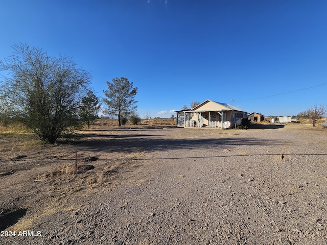 view of yard featuring a porch and a rural view