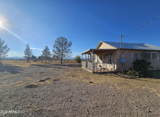 exterior space featuring a rural view and a porch