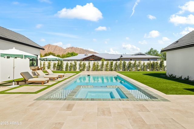 view of swimming pool with a yard, an in-ground hot tub, a mountain view, and a patio