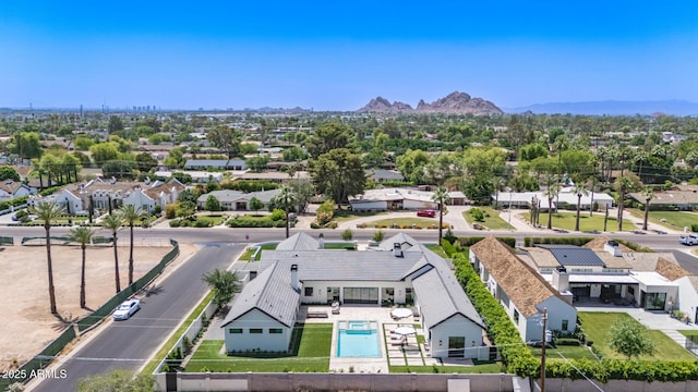 aerial perspective of suburban area featuring a pool area and mountains