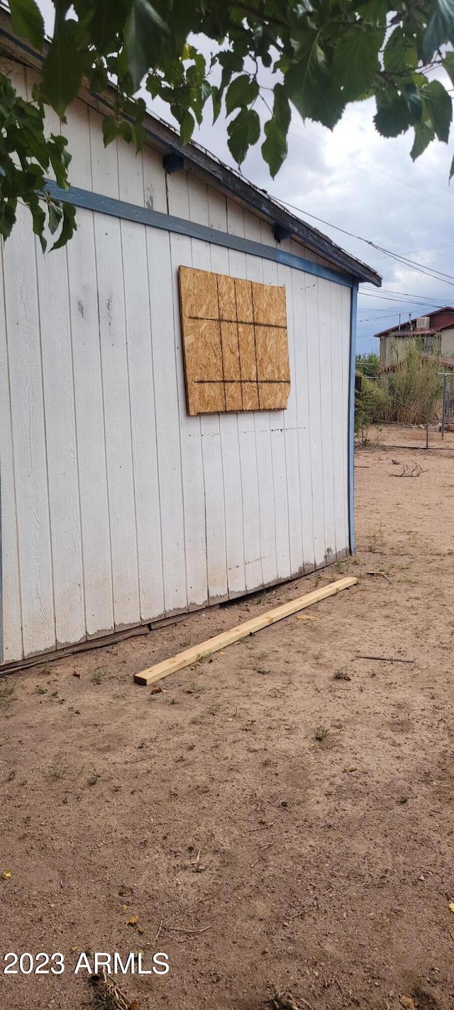 view of side of property with a shed