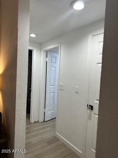 11028 W Crimson Ln, Avondale, AZ 85392 - hallway featuring light wood-type flooring, baseboards, and a textured wall