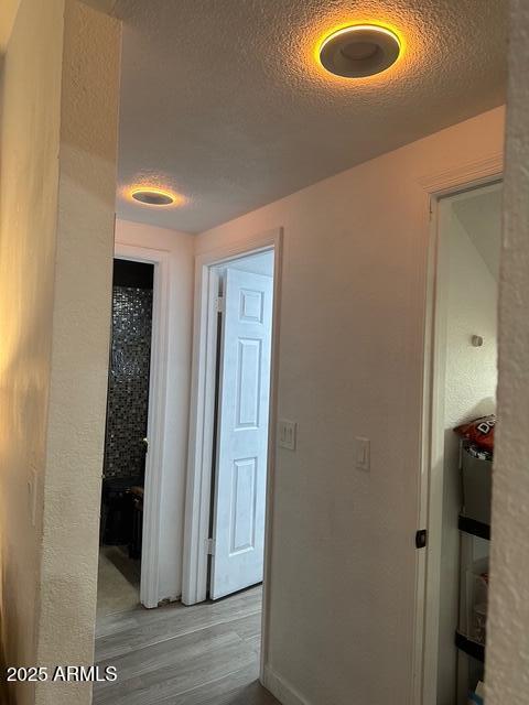 11028 W Crimson Ln, Avondale, AZ 85392 - hall featuring wood finished floors and a textured ceiling