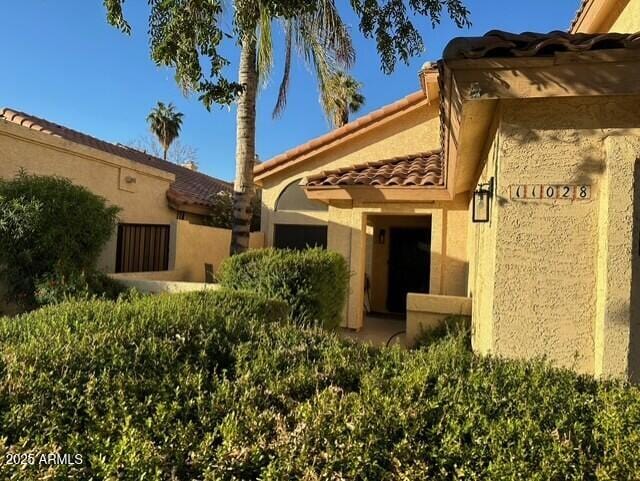 11028 W Crimson Ln, Avondale, AZ 85392 - doorway to property with a tile roof and stucco siding