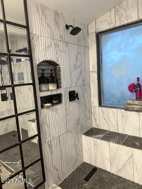 11028 W Crimson Ln, Avondale, AZ 85392 - bathroom with a tile shower and a textured ceiling