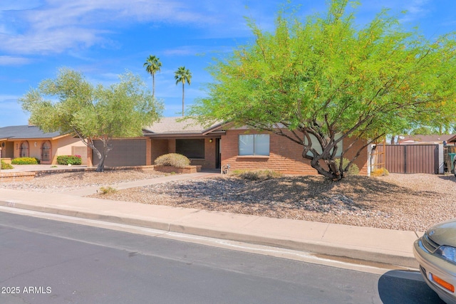 single story home with brick siding and fence