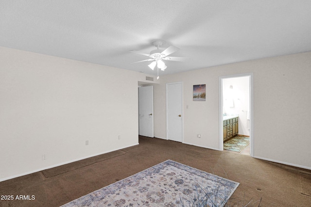 unfurnished bedroom with connected bathroom, carpet flooring, baseboards, and visible vents
