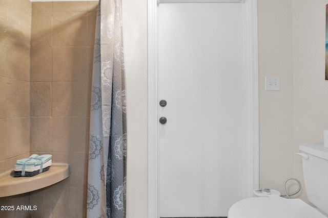 bathroom featuring toilet and a shower with curtain