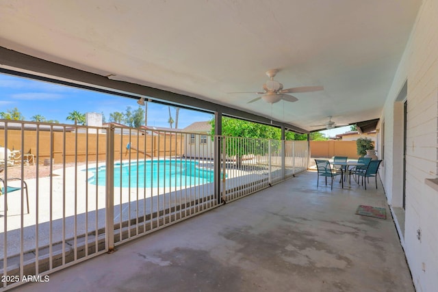exterior space with outdoor dining space, a fenced in pool, a ceiling fan, and a fenced backyard