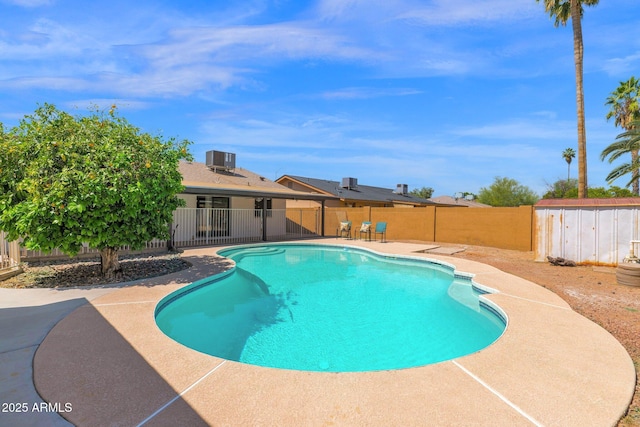 view of pool featuring a fenced in pool, a patio, central air condition unit, a fenced backyard, and a storage unit