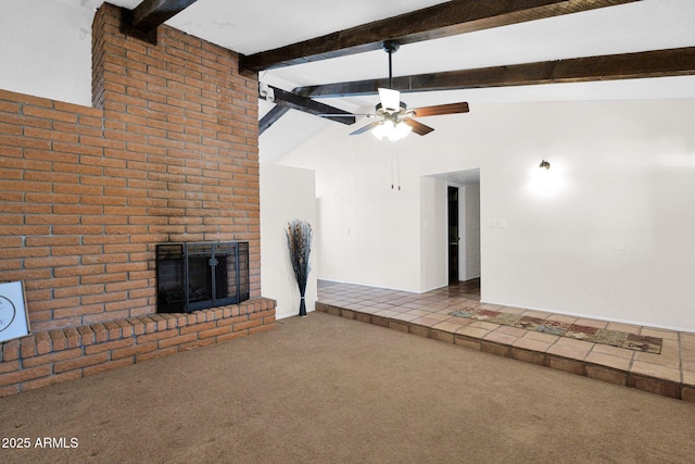 unfurnished living room featuring carpet flooring, lofted ceiling with beams, a ceiling fan, and a brick fireplace