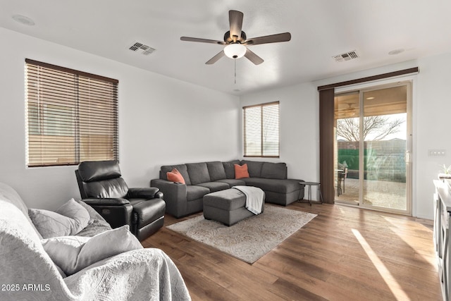 living room featuring dark hardwood / wood-style flooring and ceiling fan