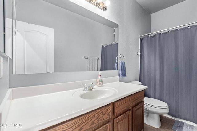 bathroom featuring vanity, tile patterned floors, and toilet