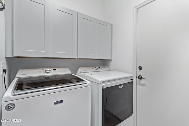 laundry room with cabinets and separate washer and dryer