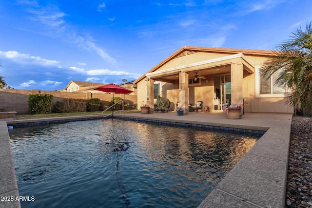 view of swimming pool with ceiling fan and a patio area