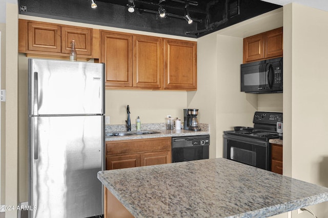 kitchen featuring sink, black appliances, and track lighting