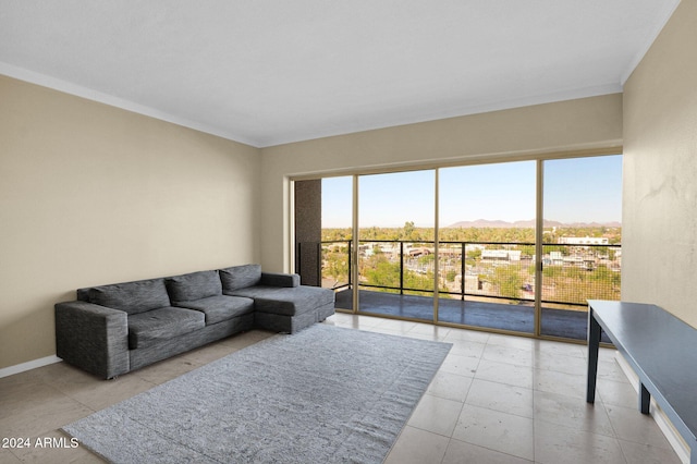 living room with a mountain view, light tile patterned floors, and ornamental molding