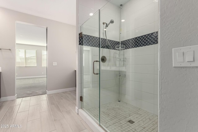 bathroom with a shower with door