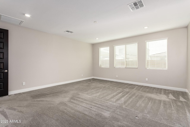 spare room with plenty of natural light and carpet flooring