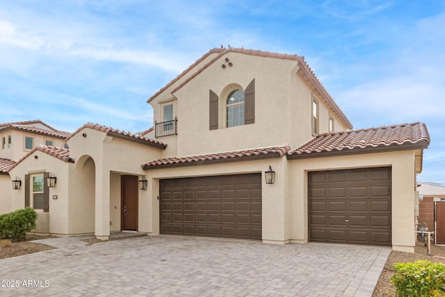 mediterranean / spanish home featuring a garage