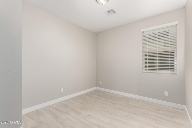 spare room with light wood-type flooring