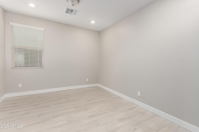 spare room featuring light hardwood / wood-style floors