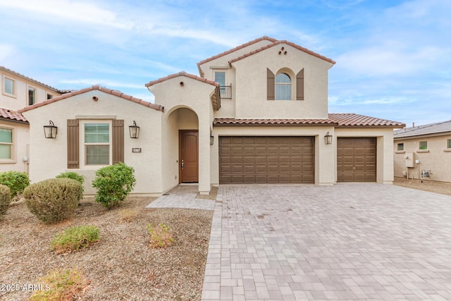 mediterranean / spanish house featuring a garage