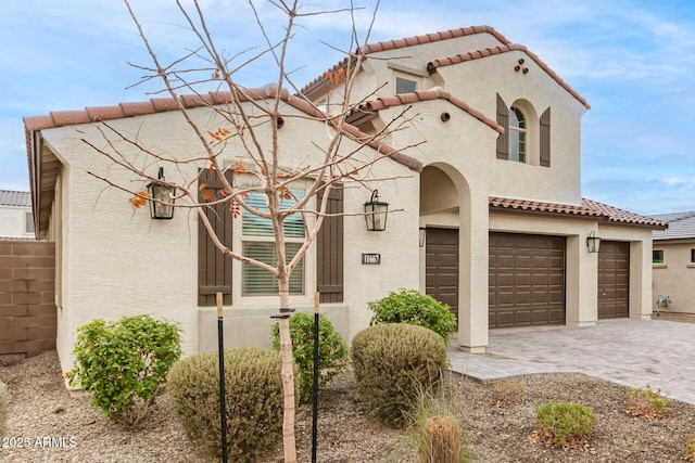 mediterranean / spanish-style house with a garage