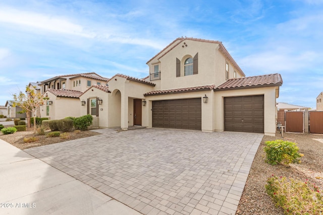 mediterranean / spanish-style house with a garage