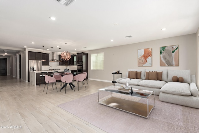 living room with sink and light hardwood / wood-style flooring