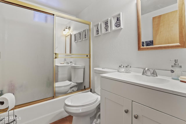 full bathroom featuring enclosed tub / shower combo, vanity, and toilet