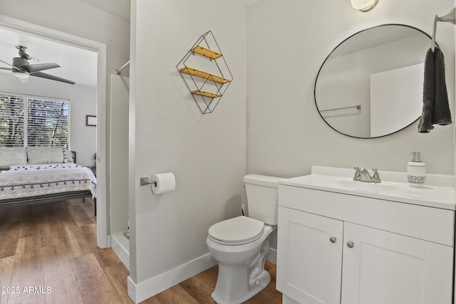 bathroom featuring hardwood / wood-style flooring, vanity, ceiling fan, and toilet