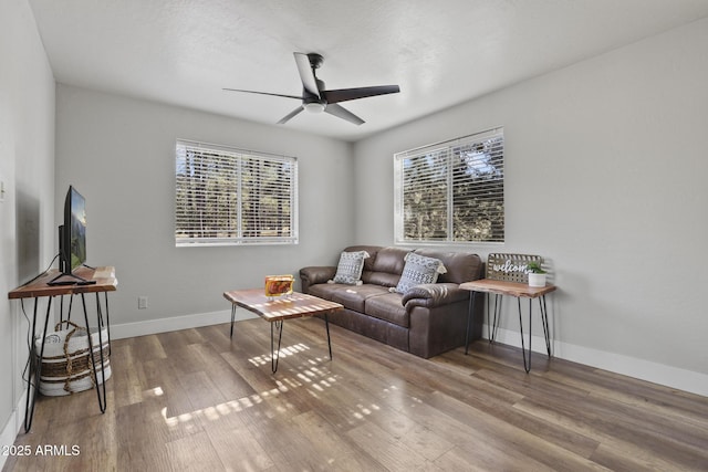 living room with hardwood / wood-style flooring, plenty of natural light, and ceiling fan