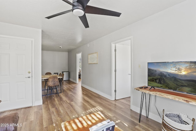 living room featuring ceiling fan and light wood-type flooring