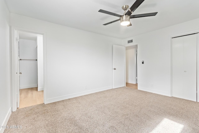 unfurnished bedroom with ceiling fan and light carpet