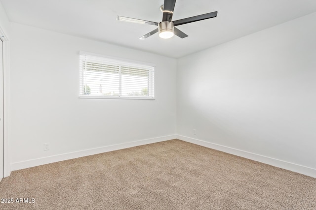 spare room featuring carpet and ceiling fan