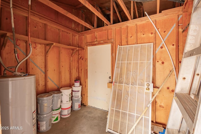 miscellaneous room with concrete flooring and gas water heater