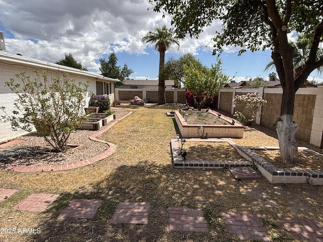 view of yard with a garden and a fenced backyard