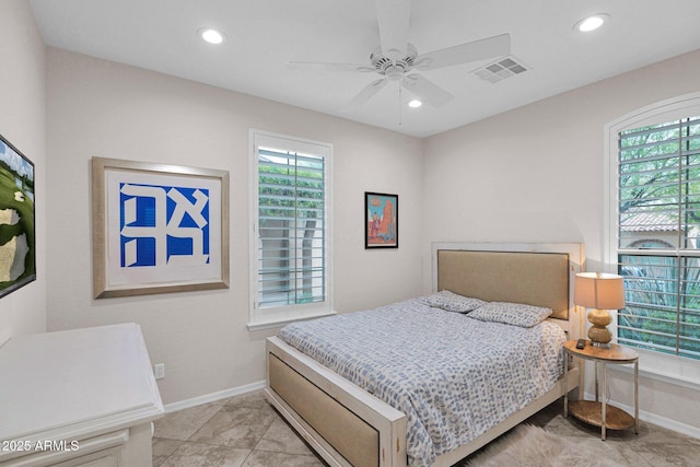 bedroom with ceiling fan and multiple windows