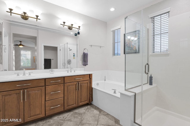 bathroom featuring tile patterned flooring, vanity, separate shower and tub, and ceiling fan