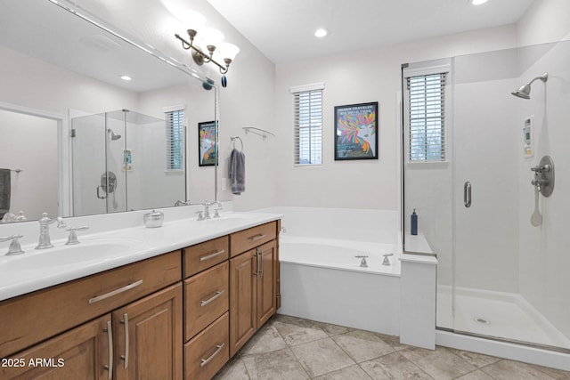 bathroom with plus walk in shower, vanity, and tile patterned floors